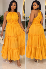 Femme portant une robe longue Mango jaune safran à volants - Bambinerie Maternità Dakar